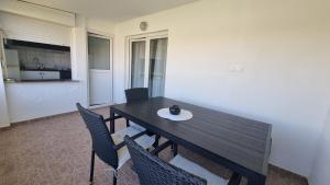 a dining table and chairs in a room at Apartments Šešo A in Pag +7 photos