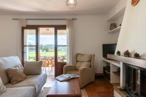 a living room with a couch and a television at New! Villa Cana Vane in Puerto de San Miguel +28 photos