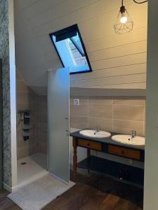 a bathroom with two sinks and a window at Ombre et Oust in Josselin +17 photos