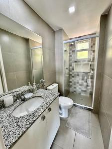 a bathroom with a sink and a toilet at Apartamento Bela Vista Porto Real Resort in Mangaratiba
