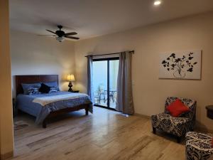 a bedroom with a bed and a window and a chair at Casa Vista Animas San Jose del Cabo in San José del Cabo +35 photos