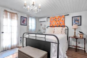 a bedroom with a bed and a chandelier at Serendipity in Fredericksburg