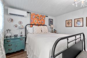 a bedroom with a bed and a blue cabinet at Serendipity in Fredericksburg