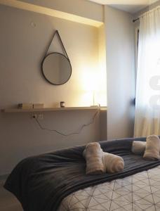a bedroom with a bed with a mirror on the wall at Nicki's cozy apartment! in Ioannina