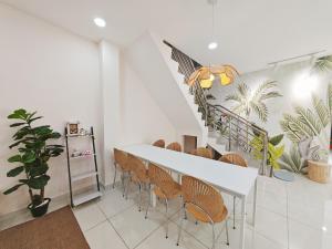a dining room with a table and chairs and a staircase at 45GeorgeTown Multi Family corner lot free parking food convenience stores nearby in George Town