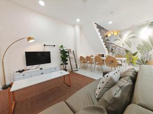 a living room with a couch and a tv at 45GeorgeTown Multi Family corner lot free parking food convenience stores nearby in George Town