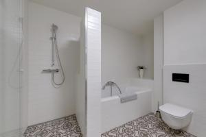 a white bathroom with a toilet and a shower at Shon apartment Old Town in Bratislava +24 photos