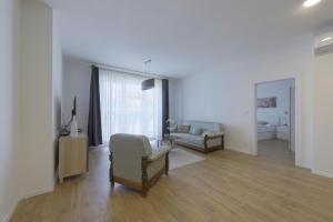 a living room with a couch and a chair at Shon apartment Old Town in Bratislava