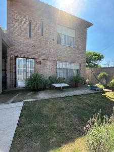 a brick house with a bench in front of it at Casa Lavanda in Embalse