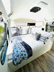 a bed in the back of an rv at Stay in Style - Airstream & Views in Spring Valley +28 photos