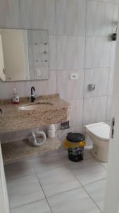a bathroom with a sink and a toilet at Hotel e Pousada Maresia & Sol in Água Boa