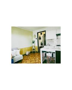 a kitchen and a living room with a table at cómodo departamento centro de Talca , estacionamiento gratuito in Talca +3 photos