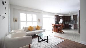 a living room with a couch and a table at Beautiful House Near Grand River & Kiwanis Park in Kitchener