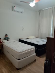two mattresses in a room with two beds at Aconchego in São Pedro da Aldeia +5 photos
