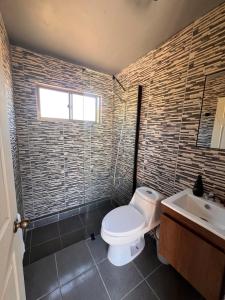 a bathroom with a toilet and a sink at Terrario Elqui Cabañas in Vicuña