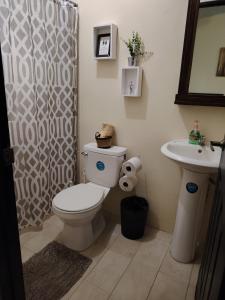 a bathroom with a toilet and a sink at Villa JR 4 near the Guacalillo Rock in Tivives