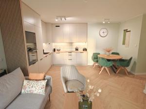 a living room with a couch and a table at Amber Coast Apartment Gdańsk in Gdańsk