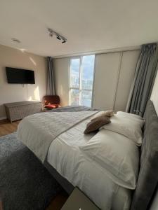 a bedroom with a large bed with a large window at Luxury apartment in the city center in Rotterdam +47 photos