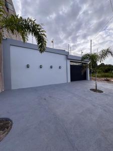 a building with a garage with a large door at Casa Alter do Sol - 3 suites in Alter do Chao