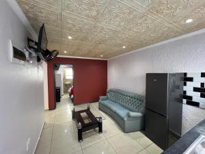 a living room with a couch and a table at Our Home Guest House in Bellville