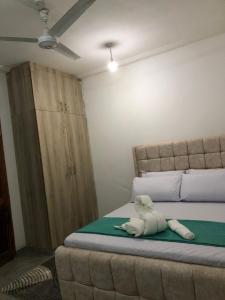 a bedroom with a bed with a stuffed animal on it at Bliss Residence Bamburi Mwembeni in Mombasa