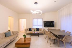 a living room with a couch and a table at Villa Lausanne - View in Dāliyat el Karmil