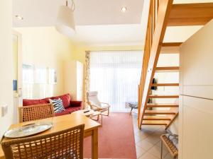 a living room with a table and a couch at Ideale Familienwohnung in der Natur in Granzow