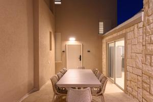 a conference room with a table and chairs at Villa Lausanne - View in Dāliyat el Karmil +37 photos