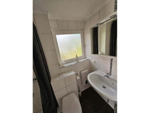 a bathroom with a sink and a toilet and a mirror at Raphael - "Frank Sinatra" in Timmendorfer Strand