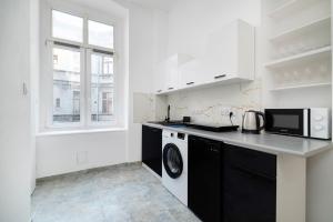 una cocina con lavadora y microondas en Centrum 2 Łódź 7 Próchnika21, en Łódź