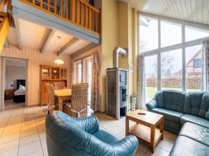 a living room with couches and a dining room with a table at Ferienhaus mit Terrasse und Balkon in Granzow