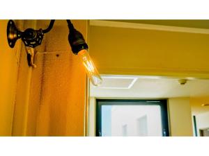 a light hanging from a wall next to a mirror at Hotel Area One Ise Inter - Vacation STAY 38519v in Ise +81 photos