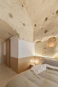 a bedroom with a large bed with a stone ceiling at La Dimora Di Metello in Matera