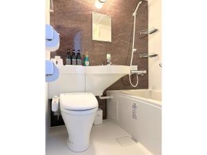 a bathroom with a toilet and a sink and a tub at Second Inn Hana Hotel Hanazono Inter - Vacation STAY 40281v in Fukaya +9 photos
