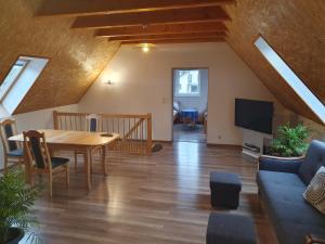 a living room with a table and a tv at Dom Porost in Porost