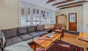 a living room with a couch and a table at Historic Charm Located On the River - Rustic Chic in Woodstock