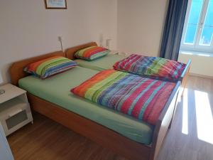 two beds with colorful pillows on them in a room at Ristorante Bellavista in Santa Maria