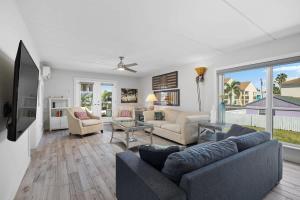 a living room with a couch and a table at Beach Paradise Getaway in South Padre Island in South Padre Island