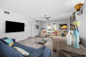 a living room with a couch and a tv at Beach Paradise Getaway in South Padre Island in South Padre Island
