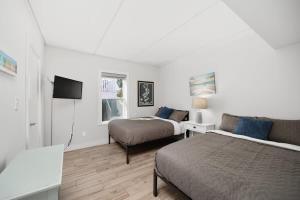 a hotel room with two beds and a couch at Beach Paradise Getaway in South Padre Island in South Padre Island +20 photos
