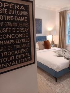 a bedroom with a bed with a poster on the wall at Sand and Salt Bed & Breakfast in White Rock