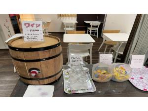a table with a wine barrel and jars of food at TAMA HOTEL - Vacation STAY 41312v in Ishinomaki