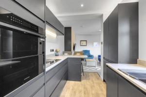 a kitchen with stainless steel appliances and a counter at The Tanner's Lodge - North East Escapes in Hexham +9 photos