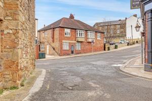 an empty street in a town with a brick building at The Tanner's Lodge - North East Escapes in Hexham