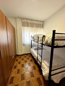 a bedroom with two bunk beds and a window at Can Guzmu in Cijuela +27 photos