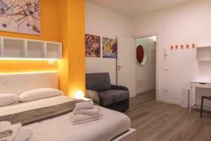 a bedroom with a bed and a chair and a desk at Locami Bi-Apartments Padova in Padova