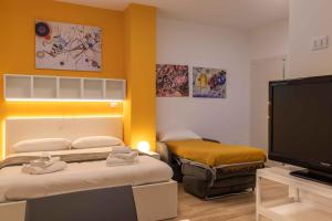 a room with two beds and a flat screen tv at Locami Bi-Apartments Padova in Padova