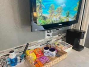 a tv sitting on top of a table with food at Reno Romantic Couples Retreat in Reno