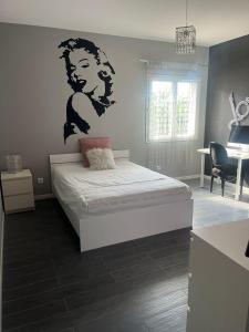 a bedroom with a bed with a mural of a woman at BELLE VILLA 8 à 10 personnes parc du verdon in La Verdière +11 photos