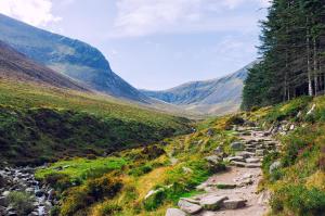 a mountain path through a valley with mountains in the background at Newry Premium B&B in Newry